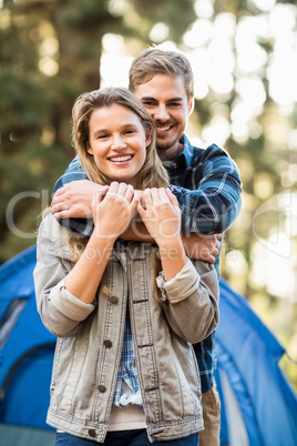 Happy young camper couple looking at the camera