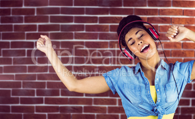 A smiling woman dancing with headphones