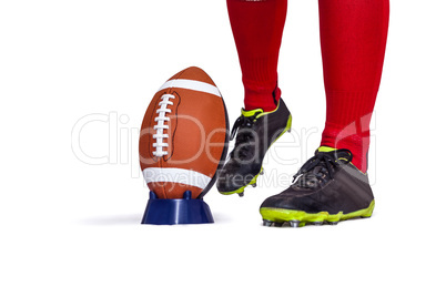 American football player about to kick the ball