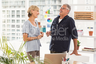 Happy business team laughing together