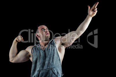 Handsome bodybuilder posing with arms up