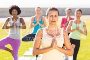 Peaceful sporty brunette doing yoga in yoga class