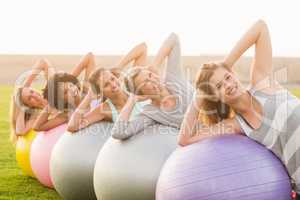 Smiling sporty women working out with exercise balls