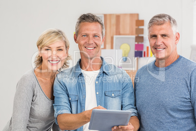 Smiling business colleagues working on a tablet Smiling business colleagues working on a tablet