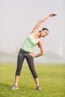 Sporty woman stretching arms