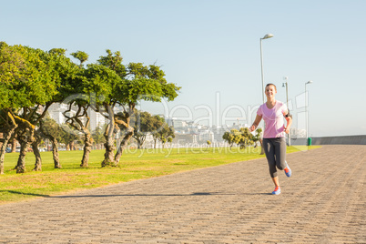 Focused sporty blonde jogging at promenade Focused sporty blonde jogging at promenade