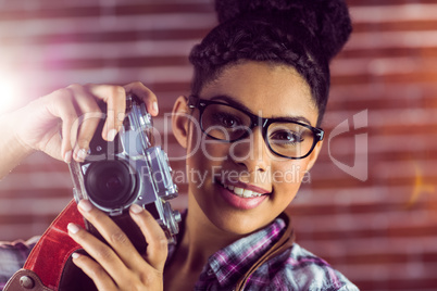 Portrait of a young hipster taking a picture