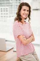 Smiling casual businesswoman with arms crossed