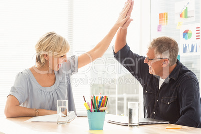 Happy business team doing a high-five