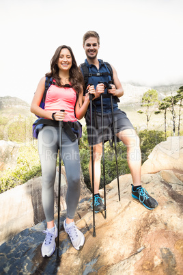 Young happy joggers standing on rock