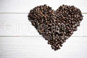 Coffee beans on a table in heart shape