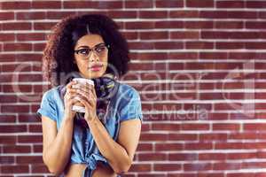 Attractive hipster holding take-away cup