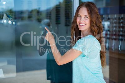 Pretty woman pointing at window