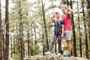 Young happy hiker couple looking away