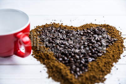 Coffee on a table in heart shape with cup