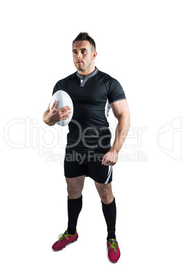 Tough rugby player holding ball
