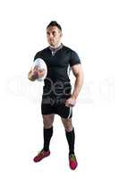 Tough rugby player holding ball