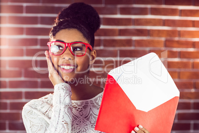 Beautiful smiling hipster holding a big envelope