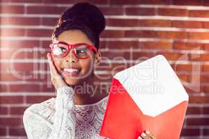 Beautiful smiling hipster holding a big envelope