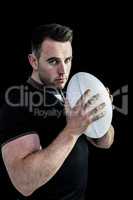 Tough rugby player holding ball