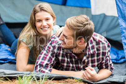 Young pretty hiker couple lying in a tent