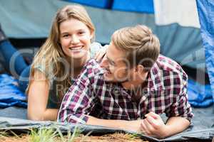 Young pretty hiker couple lying in a tent