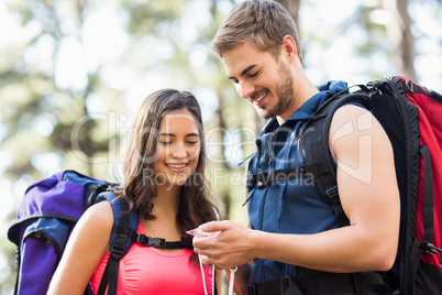 Young happy joggers looking at compass