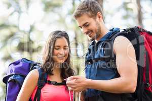 Young happy joggers looking at compass