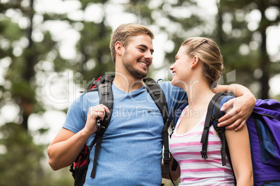 Young happy hikers looking at each other