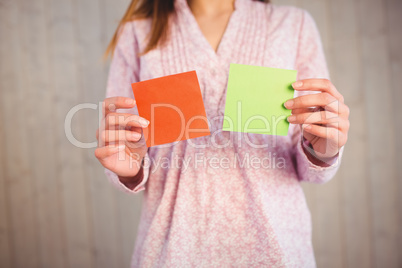 Woman holding green and orange cards