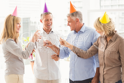 Casual business people making birthday toasts