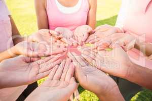 Women wearing pink for breast cancer and showing hands