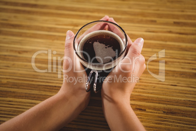 Womans hands holding cup of coffee