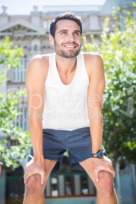 Smiling handsome athlete resting