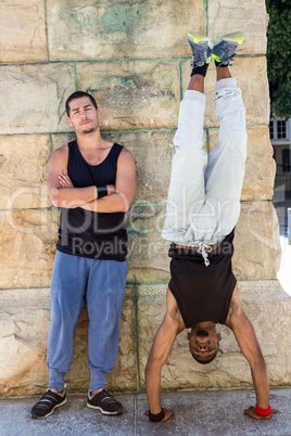 Happy friends doing parkour in the city