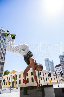 Handsome athlete doing a headstand