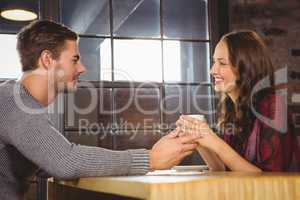 Smiling couple talking and drinking coffee