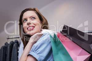 Woman holding shopping bags over shoulder