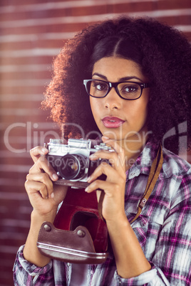 Attractive hipster photographing with camera