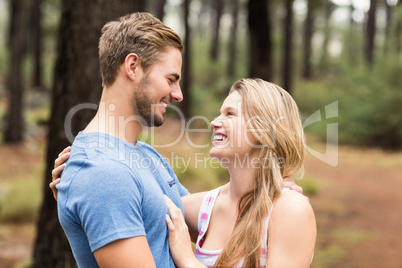 Young happy hiker couple looking at each other