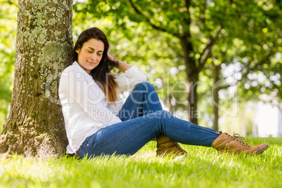 Beautiful brunette relaxing in the park