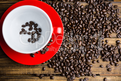 Coffee beans on a table with cup