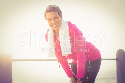 Smiling sporty woman listening to music
