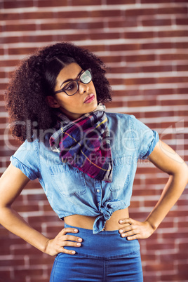 Attractive hipster posing with hands on hips