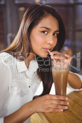 Portrait of a beautiful woman drinking a hot chocolate