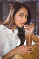 Portrait of a beautiful woman drinking a hot chocolate