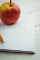 View of an apple and notepad