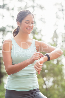 Happy jogger looking at watch