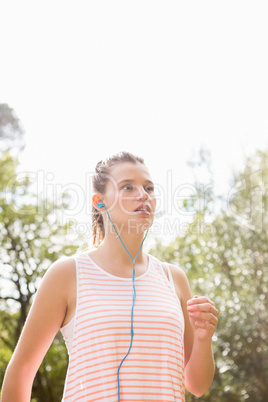 Blonde athlete jogging on trail