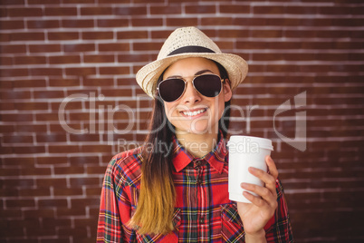 Beautiful hipster with disposable coffee